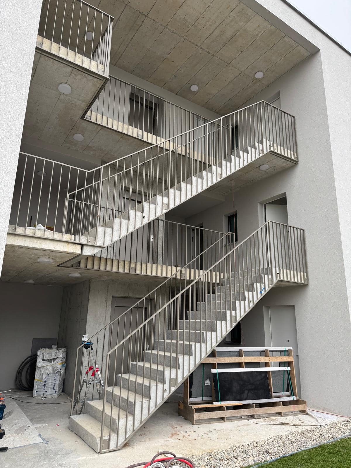 Fabricated metal stair and balcony railings shown as a supply and delivery example